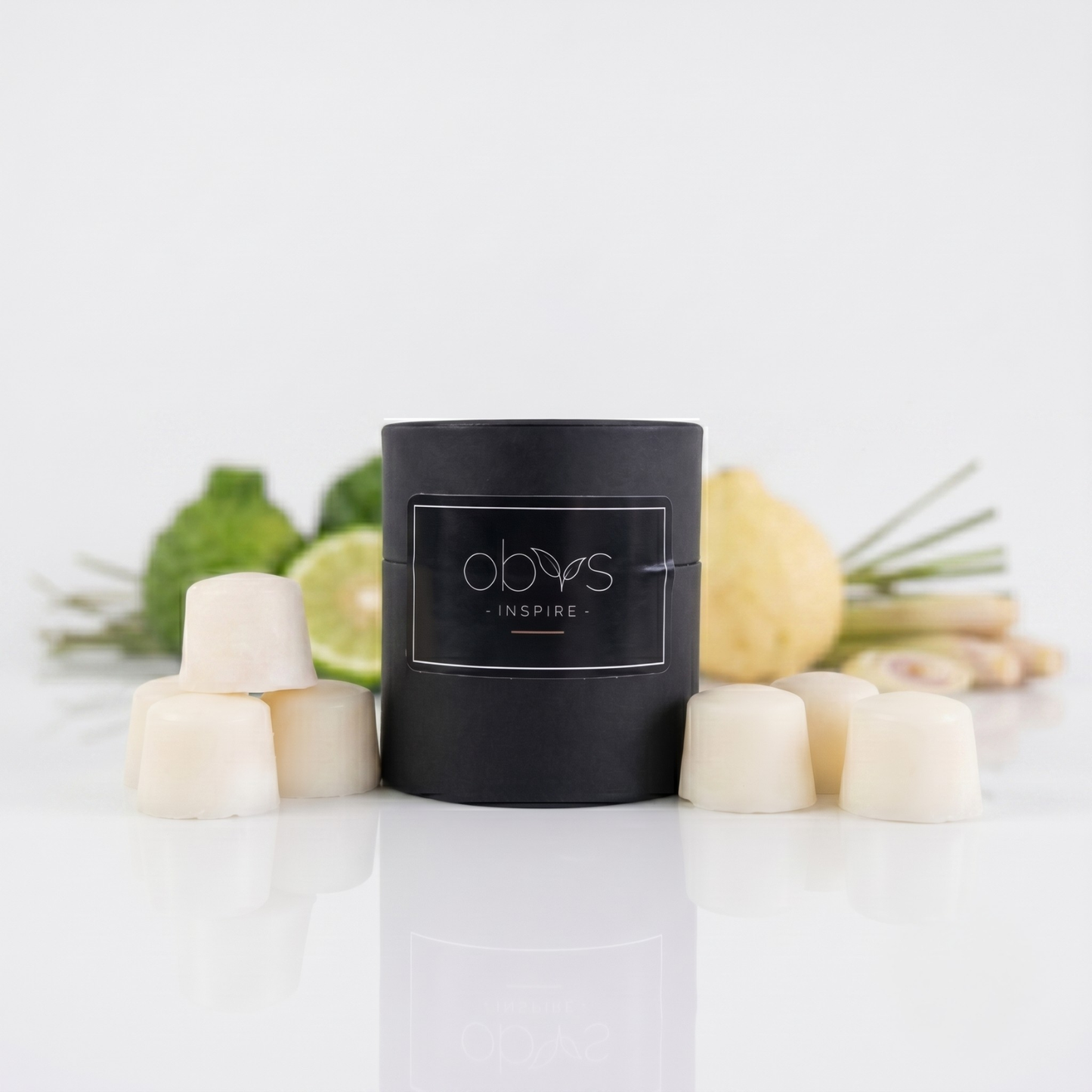 Black cylindrical container with 'obvs' branding on a white surface with decorative elements wax melts