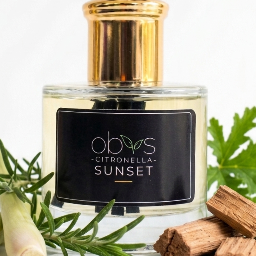 Perfume bottle labeled 'Citronella Sunset' with lemongrass and wood pieces on a white background