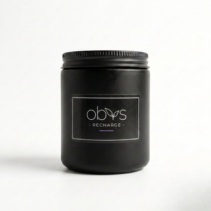 Black candle with Obvs' label on a white background