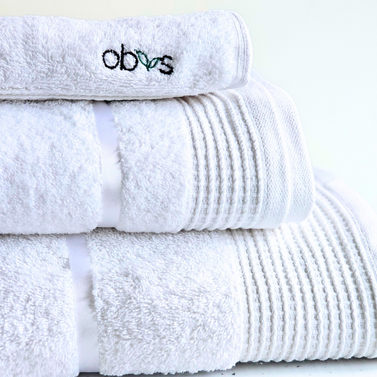 Indulge in the ultimate luxury with the Obvs at Home GOTS Certified Organic Towel Bundle. Crafted from the softest organic cotton, this collection—featuring a bath towel, hand towel, and Obvs face cloth—wraps you in pure, soothing comfort. The plush texture caresses your skin, elevating your daily ritual to an experience of serene indulgence. Eco-friendly and exquisitely soft, these towels are a true testament to sustainable luxury. Perfect for those who seek both indulgence and mindfulness in every moment.