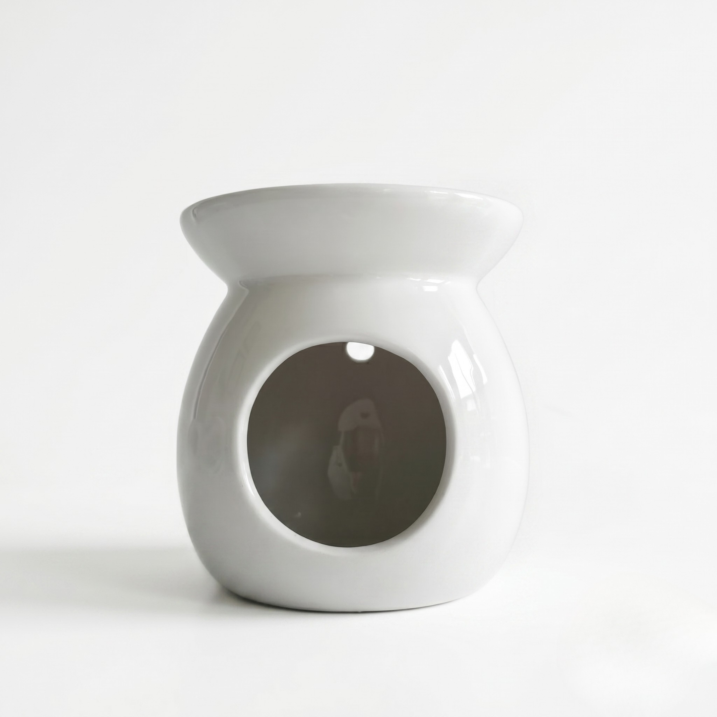 White ceramic oil burner on a white background