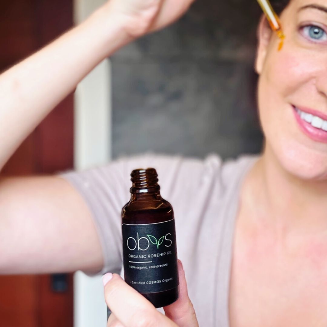 organic rosehip oil bottle with amber hue rich in essential fatty acids vitamins A C and E for anti aging hydration and skin repair