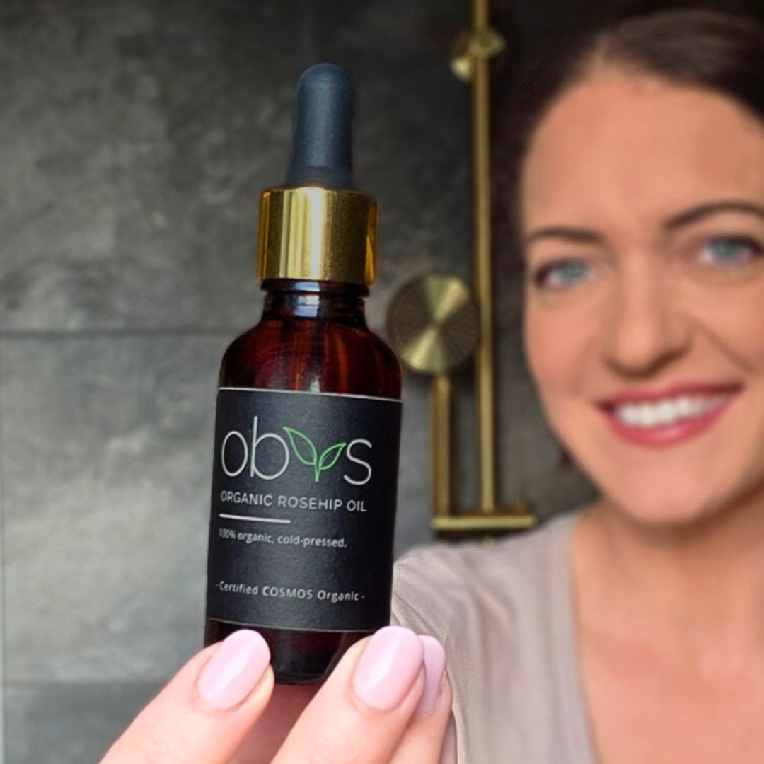 organic rosehip oil bottle with amber hue rich in essential fatty acids vitamins A C and E for anti aging hydration and skin repair