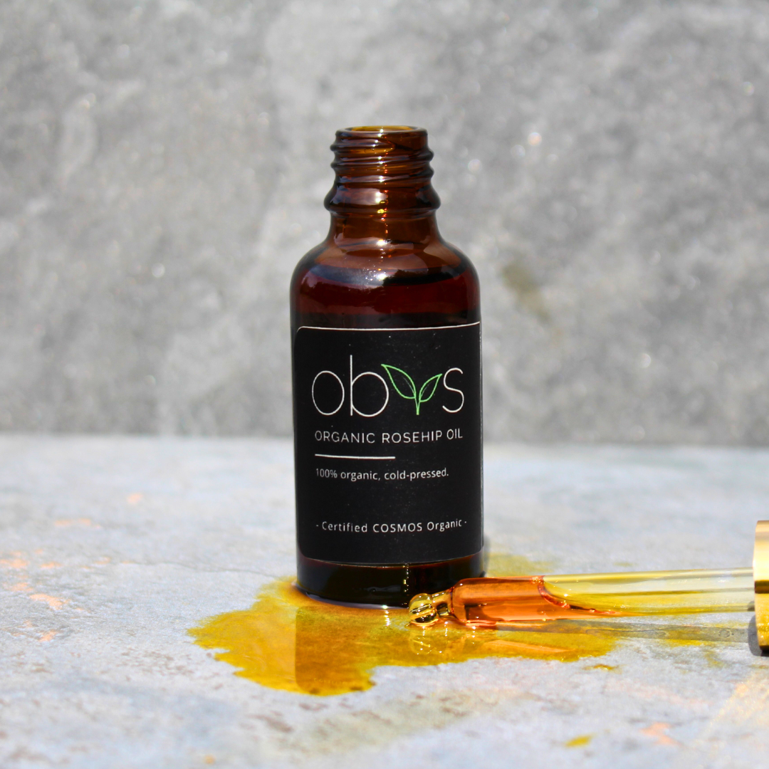 organic rosehip oil bottle with amber hue rich in essential fatty acids vitamins A C and E for anti aging hydration and skin repair