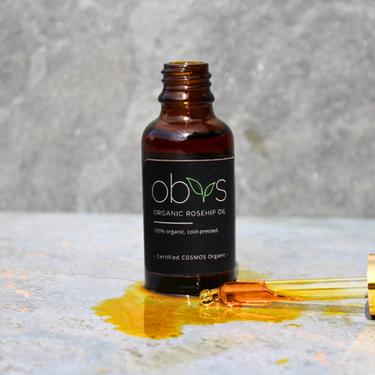 organic rosehip oil bottle with amber hue rich in essential fatty acids vitamins A C and E for anti aging hydration and skin repair