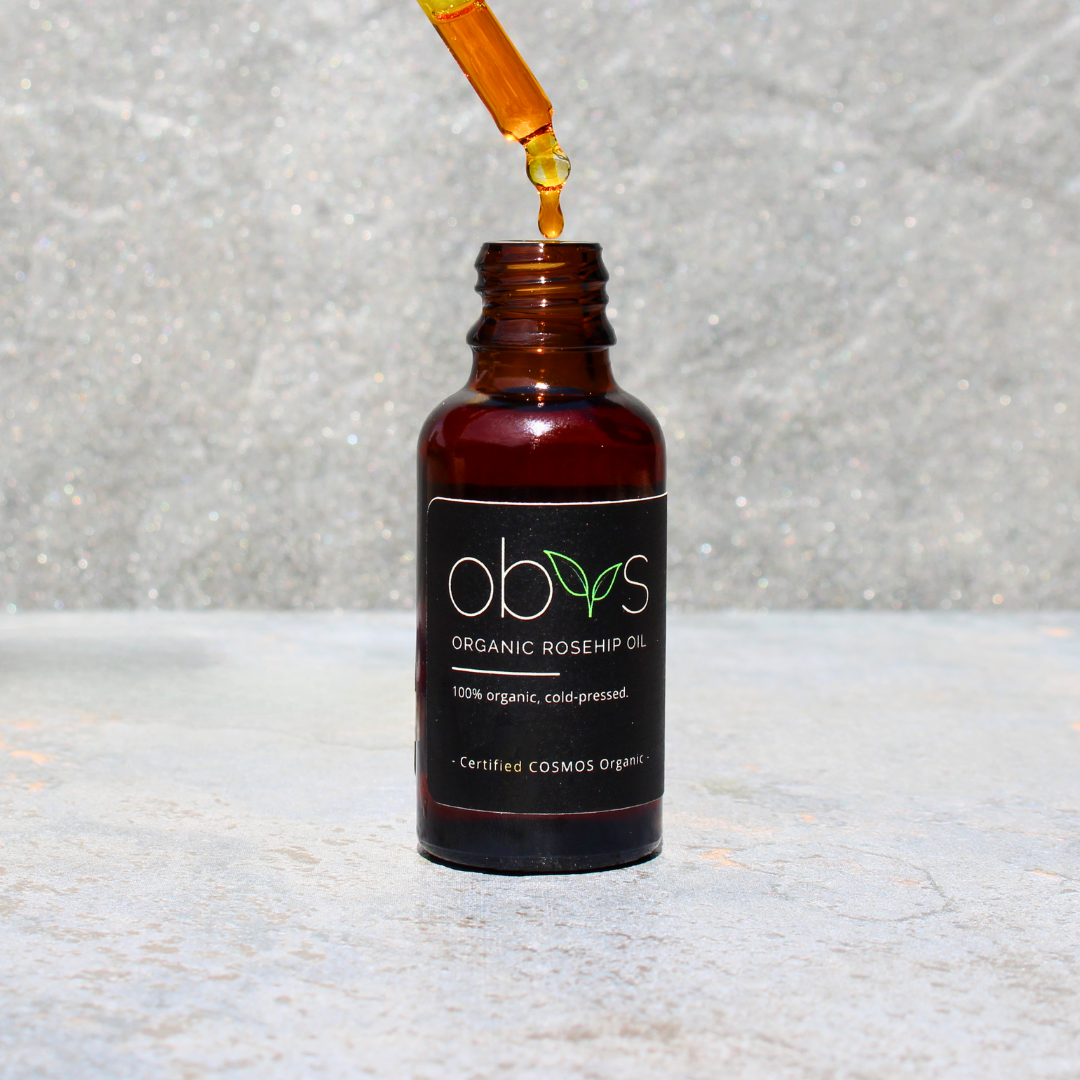 organic rosehip oil bottle with amber hue rich in essential fatty acids vitamins A C and E for anti aging hydration and skin repair