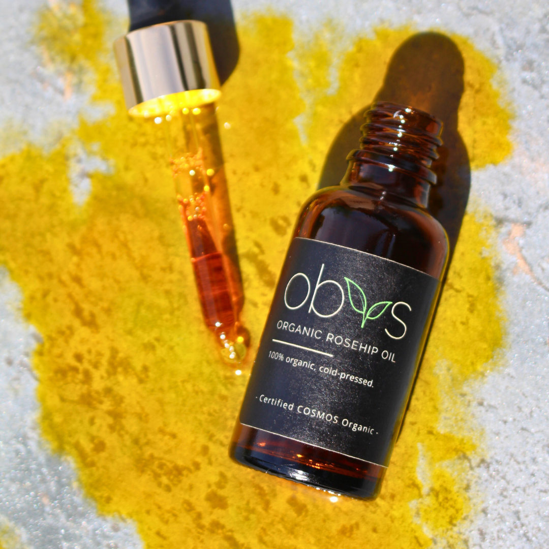 organic rosehip oil bottle with amber hue rich in essential fatty acids vitamins A C and E for anti aging hydration and skin repair