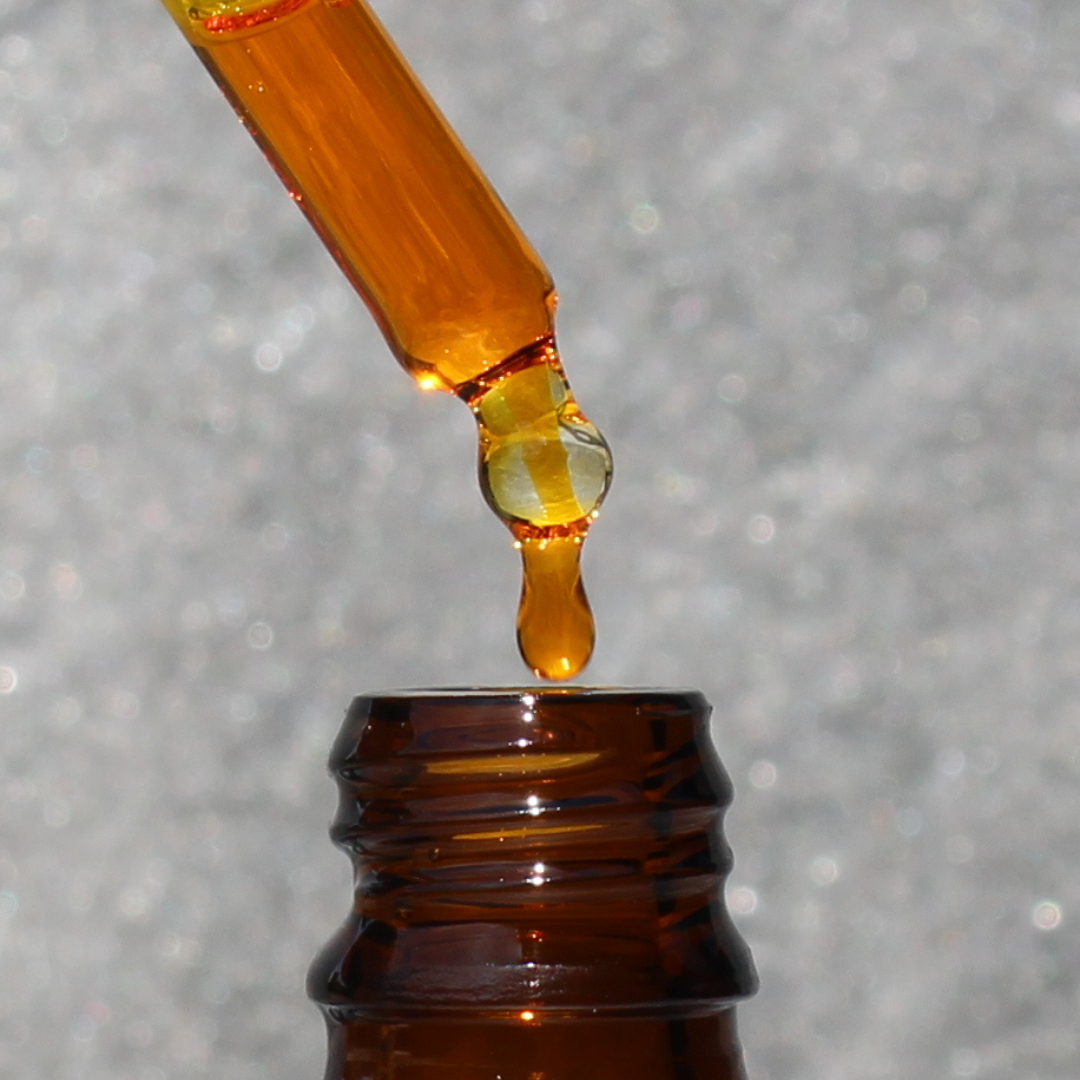 organic rosehip oil bottle with amber hue rich in essential fatty acids vitamins A C and E for anti aging hydration and skin repair